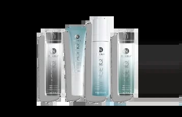 Four cylindrical skincare product bottles in silver and light blue packaging arranged in a row