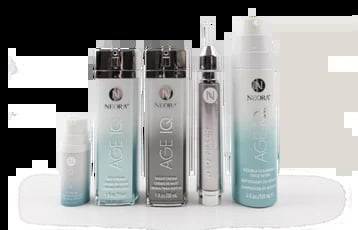 Collection of five beauty or skincare product bottles in white and blue gradient packaging arranged in a row