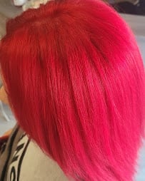 Close-up of vibrant hot pink hair with straight strands flowing downward